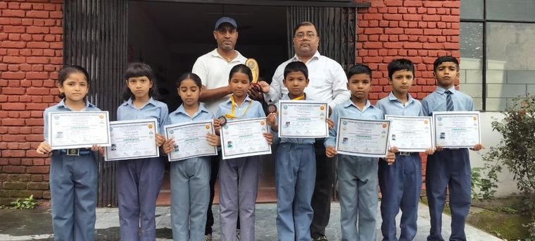Students of Janhit World School with their competition certificates