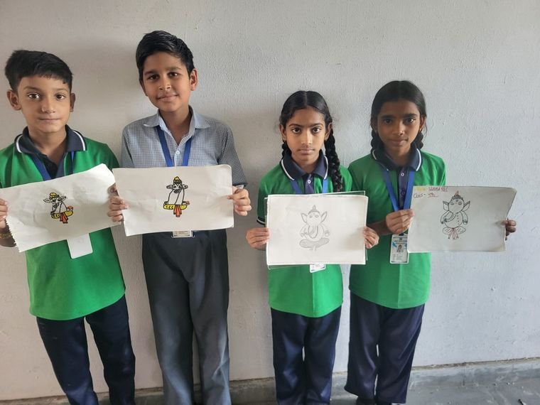 Students holding their drawings at the art competition, Janhit World School