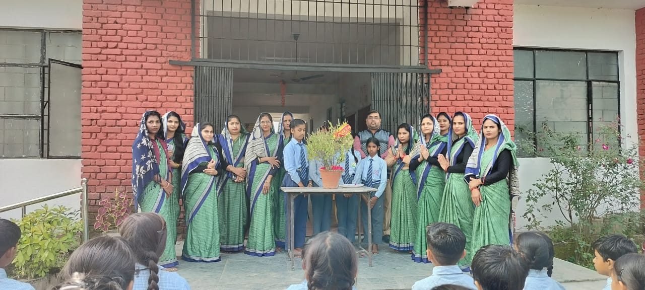 Teachers and students gathered outside the main building of Janhit World School