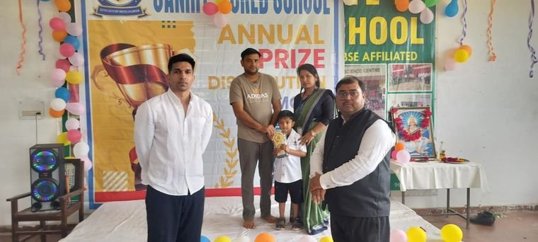 A student of Janhit World School receiving an award at the Annual Prize Distribution Ceremony